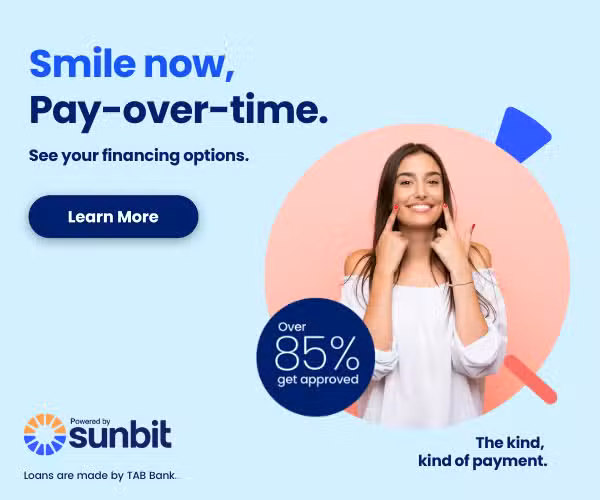 A promotional banner for Sunbit financing featuring a smiling woman pointing to her teeth. The text reads Smile now, Pay-over-time. See your financing options. It highlights that over 85% of applicants get approved. The Sunbit logo and Powered by TAB Bank are shown at the bottom with a Learn More button.